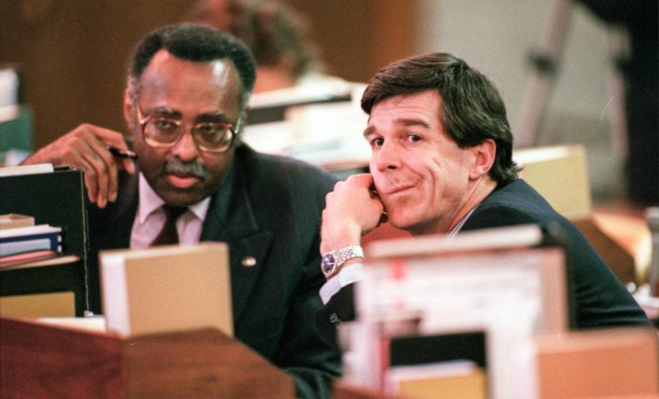 Sen. Roy Cooper, right, and Sen. Bill Martin talk on the floor of the Senate in August 1997.