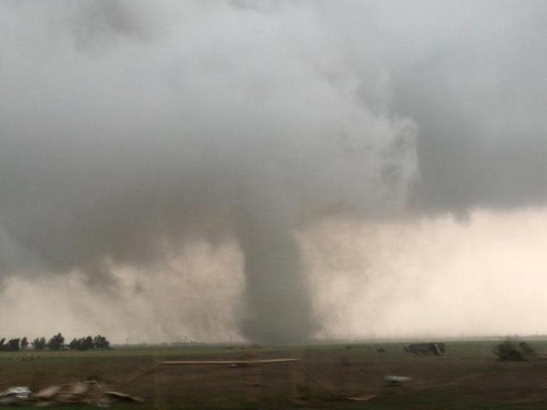 Swathes of Oklahoma and Arkansas remain under the threat of tornadoes on Tuesday, forecasters have warned, with one confirmed twister already spawning over Tulsa airport."A bowing line of thunderstorms with embedded ... vortices will continue to pose a damaging-wind and tornado threat, with isolated large hail, as it crosses the watch area through the morning," the National Weather Service said.A tornado-watch area extends over eastern central and northeast Oklahoma and northwest Arkansas, with forecasters urging residents to be prepared. It follows days of extreme weather with dozens of the storms touching down.Please allow a moment for the live blog to load