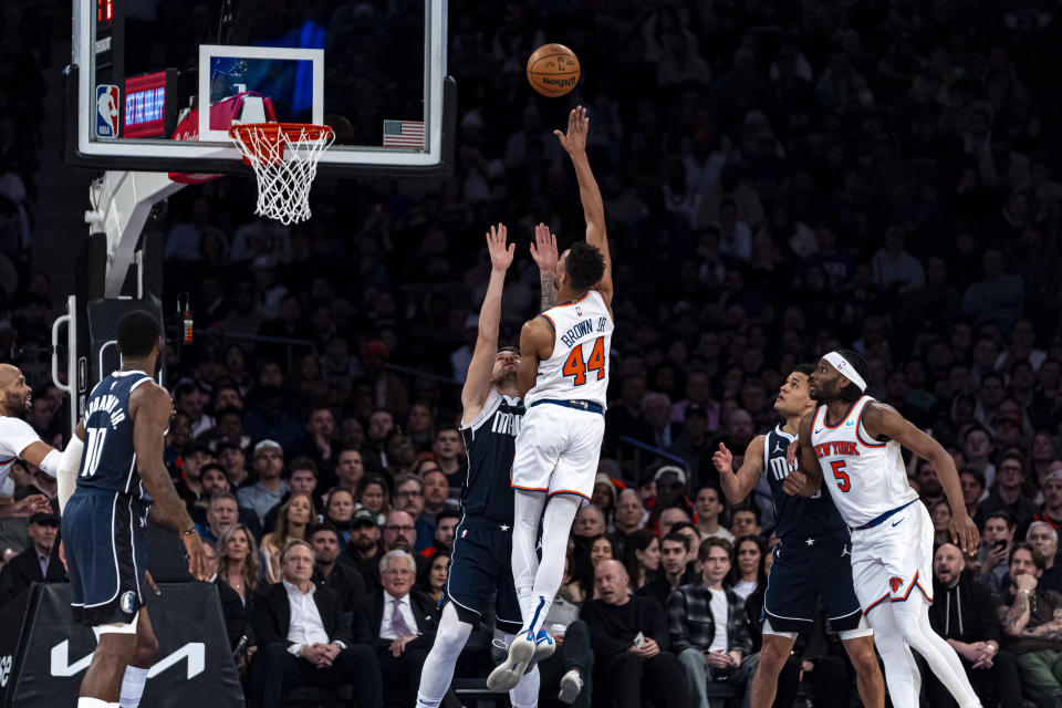 New York Knicks guard Charlie Brown Jr. (44) shoots over Dallas Mavericks guard Luka Doncic, center left, during the first half of an NBA basketball game in New York, Thursday, Feb. 8, 2024. (AP Photo/Peter K. Afriyie)