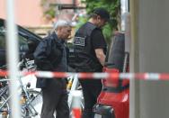 Police work at a site where a Syrian migrant set off an explosive device in Ansbach, southern Germany, on July 25, 2016