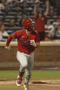 Philadelphia Phillies' Bryce Harper runs after hitting a sacrifice fly during the fifth inning of a baseball game against the New York Mets, Sunday, Sept. 19, 2021, in New York. (AP Photo/Jason DeCrow)