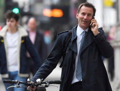 FILE PHOTO: Britain's Secretary of State for Health Jeremy Hunt walks towards Downing Street in London, May 15, 2017. REUTERS/Toby Melville/File Photo