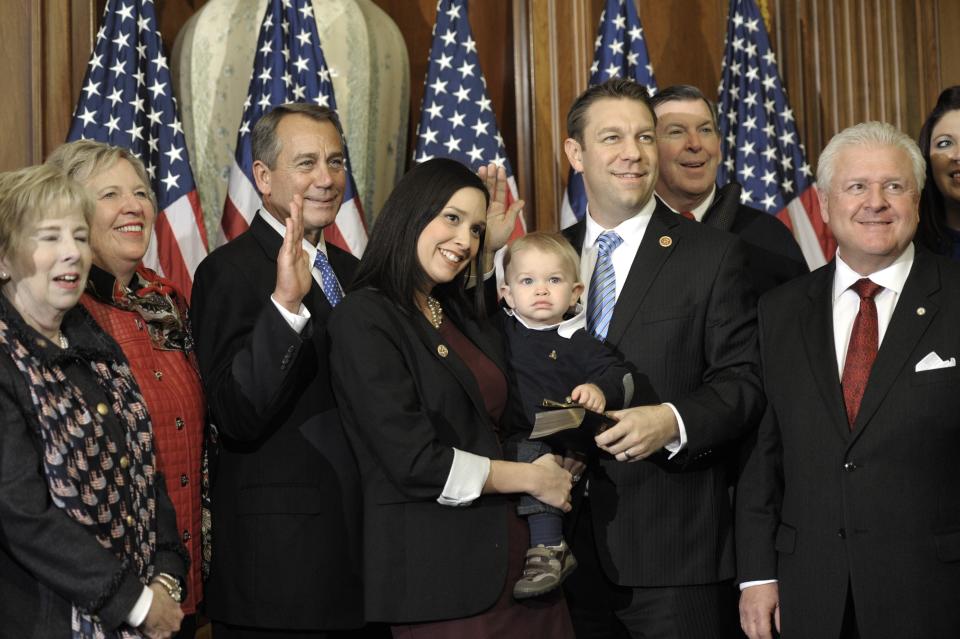 House Speaker John Boehner of Ohio, third from left, performs a mock swearing in for Rep. Trey Radel, R-Fla., third from right, Thursday, Jan. 3, 2013, on Capitol Hill in Washington as the 113th Congress began. (AP Photo/Cliff Owen) 