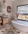 <p> If you're blessed with idyllic landscapes of a farm or some forestry, make good use of it by positioning your bath and windows next to it. Depending on the privacy you have around your estate, you may need to dress your windows to bathe with dignity. </p> <p> In this dreamy modern bathroom idea by Susannah Hawkins (aka @shnordic), a freestanding tub from Waters Baths offers the perfect views of the idyllic outdoors. She's also managed to bring the outside in with a concrete sink by Kast Concrete Basins and natural textures of wood incorporated via her Crosswater vanity and rattan shelf design. The hexagonal tiles, by Claybrook Studio remind us of a beehive too! </p> <p> Lighting from Dowsing and Reynolds and a mirror from Cox and Cox ensures that along with the natural sunlight to help, this room feels airy and bright. </p> <p> Brass finished taps by Grohe offer a glamorous touch, and the Mandala-detailed rug from TK Maxx offers color and texture and a way to dry off wet feet after enjoying a long, relaxing soak. </p>