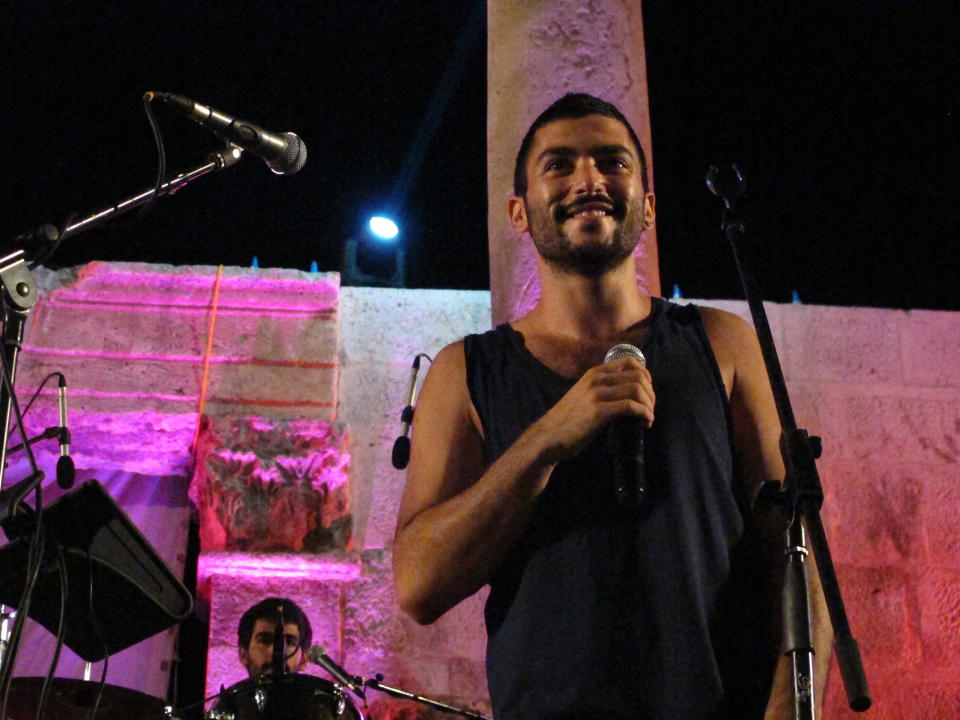 FILE - In this Friday, Sept. 14, 2012 file photo, Hamed Sinno, 24, lead singer and song writer of the Lebanese group Mashrou' Leila performs with the band in the ancient Roman amphitheater in the Jordanian capital Amman. A Lebanese band that supports gay rights has found itself at the center of a heated debate in Lebanon about freedom of expression. Church leaders and conservative politicians demand that a concert by Mashrou' Leila in the coastal city of Byblos be canceled, setting off a storm of indignation on social media. (AP Photo/Diaa Hadid, File)