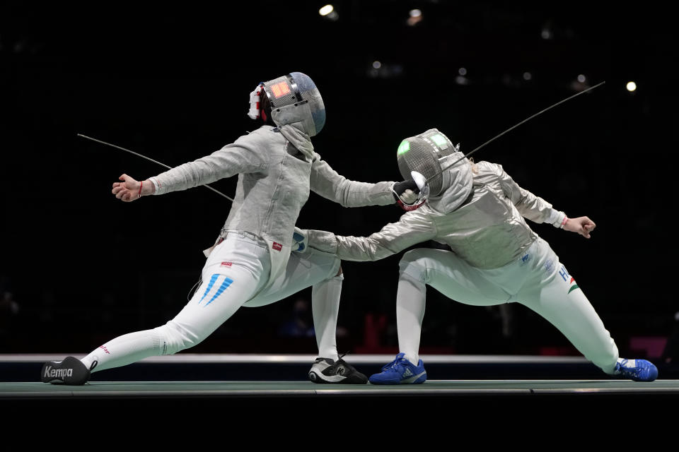 Maria Belen Perez Maurice of Argentina, left, and Anna Marton of Hungary compete in the women's individual round of 32 Sabre competition at the 2020 Summer Olympics, Monday, July 26, 2021, in Chiba, Japan. (AP Photo/Hassan Ammar)