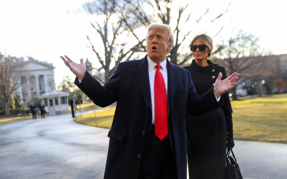 Donald Trump gestures as he and Melania Trump depart the White House  - Reuters