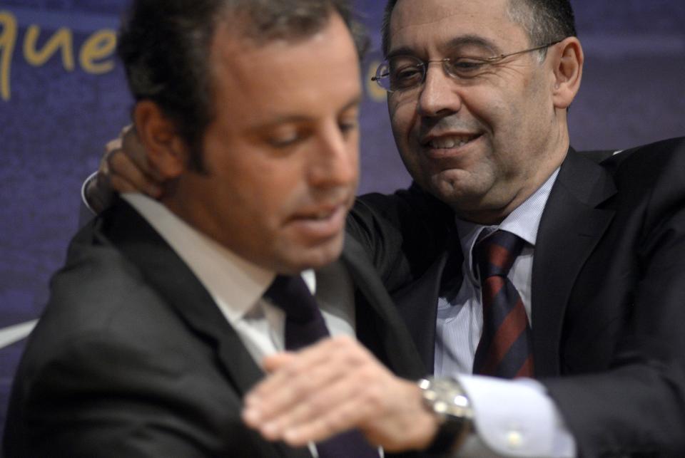 FC Barcelona's President Sandro Rosell, left, hugs to Vice-president Josep Maria Bartomeu, after a press conference at the Camp Nou stadium in Barcelona, Spain, Thursday, Jan 23, 2014. Sandro Rosell is stepping down as president of Barcelona a day after a judge agreed to hear a lawsuit accusing him of allegedly hiding the cost of the transfer of Brazil striker Neymar.Rosell says he is resigning after an emergency meeting with Barcelona's board of directors on Thursday. Rosell says vice president Josep Bartomeu will take his place as president and finish the term that expires in 2016. Elected in 2010 to replace outgoing president Joan Laporta, Rosell said last April he planned to run for re-election in 2016. (AP Photo/Manu Fernandez)