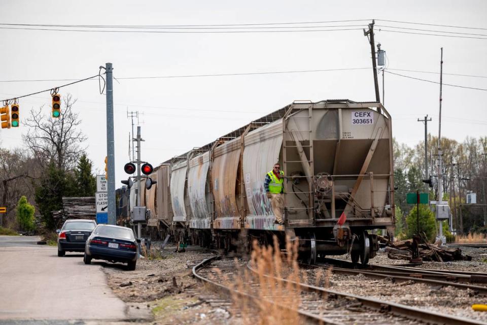 A train travels along the tracks near the Driver Street crossing in Durham on March 22, 2024. A man was killed at the crossing earlier this month when his car became trapped between the crossing arms.