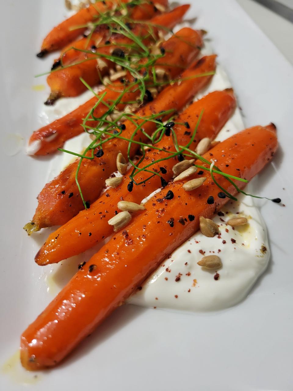 Honey roasted carrots with labne, za'tar, sumac, sunflower seed and micro chive at The Raconteur in Pleasantville.