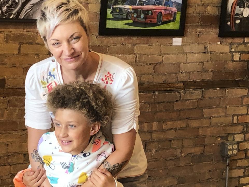 This Friday, August 28, 2020 photo shows Alexis Arnold, 44, a gallery and gift shop owner in De Pere, Wis., with her 6-year-old daughter Jade Arnold. Arnold has watched and worried all summer as protests over racial injustice at times spiraled to violence. First, she called friends in Portland for firsthand accounts. After it happened in Kenosha, a place not unlike the suburb where she's raising her daughter, she wondered out loud, “Why are we so broken right now?” (AP Photo/Kathleen Hennessey)