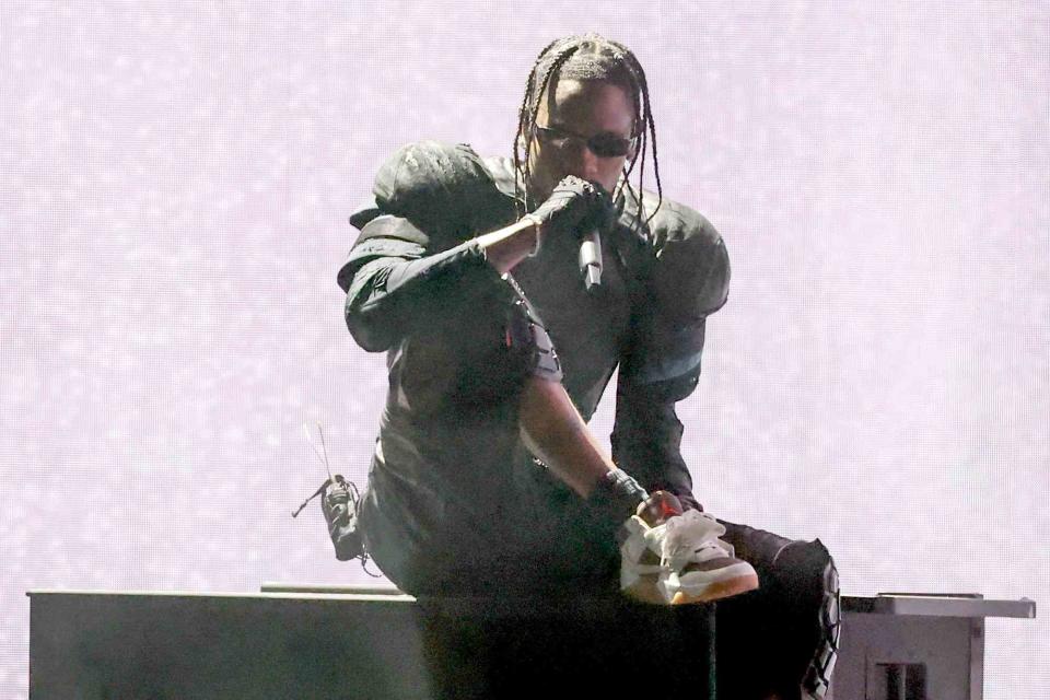 <p>Amy Sussman/Getty Images</p> Travis Scott performs at the 2024 Grammys
