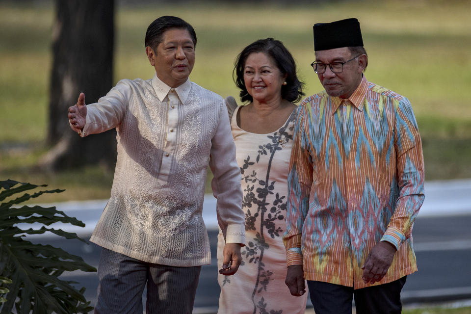 Malaysian Prime Minister Anwar Ibrahim, right, walks together with Philippine President Ferdinand Marcos Jr. and First Lady Liza Araneta Marcos during a welcome ceremony at Malacanang Palace on Wednesday, March 1, 2023 in Manila, Philippines. (Ezra Acayan/Pool Photo via AP)