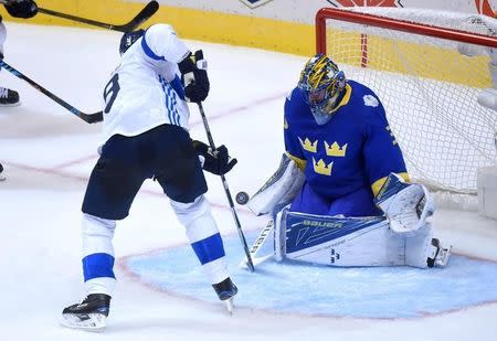 Sep 20, 2016; Toronto, Ontario, Canada; Team Sweden goalie Henrik Lundqvist (30) makes a stop in front of Team Sweden forward Mikko Koivu (9) during preliminary round play in the 2016 World Cup of Hockey at Air Canada Centre. Mandatory Credit: Dan Hamilton-USA TODAY Sports