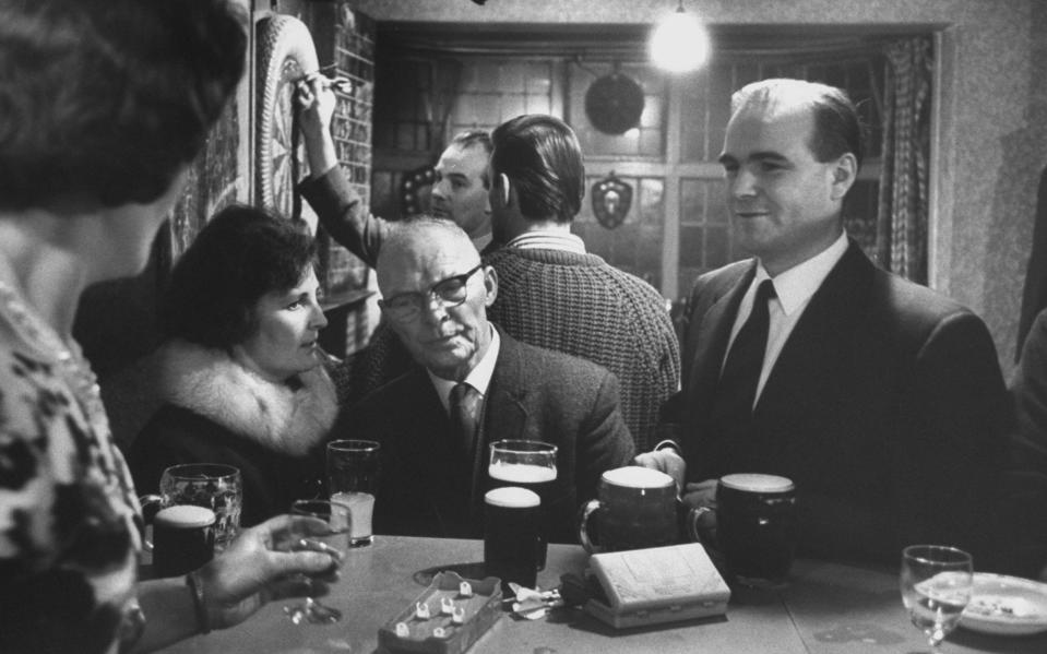 Toolmaker at leisure: Ray Willis with his wife and father-in-law at his sister’s pub, 1965, from a photo-essay by Terence Spencer - Popperfoto / Getty