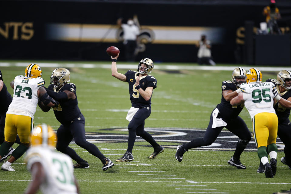 New Orleans Saints quarterback Drew Brees (9) passes under pressure from Green Bay Packers defensive end Billy Winn (93) and nose tackle Tyler Lancaster (95) in the first half of an NFL football game in New Orleans, Sunday, Sept. 27, 2020. (AP Photo/Butch Dill)