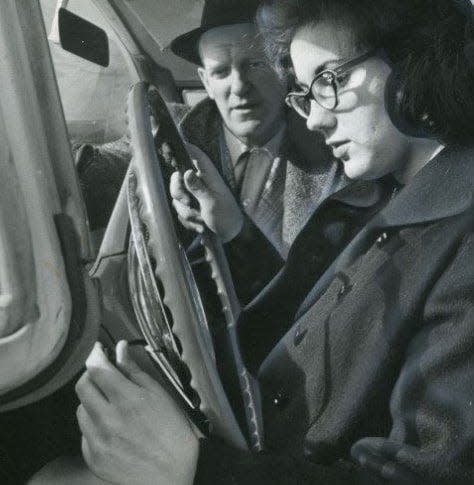 North High School junior Mary Ann Grande learns to drive under the tutelage of teacher Warren Creed in 1958.