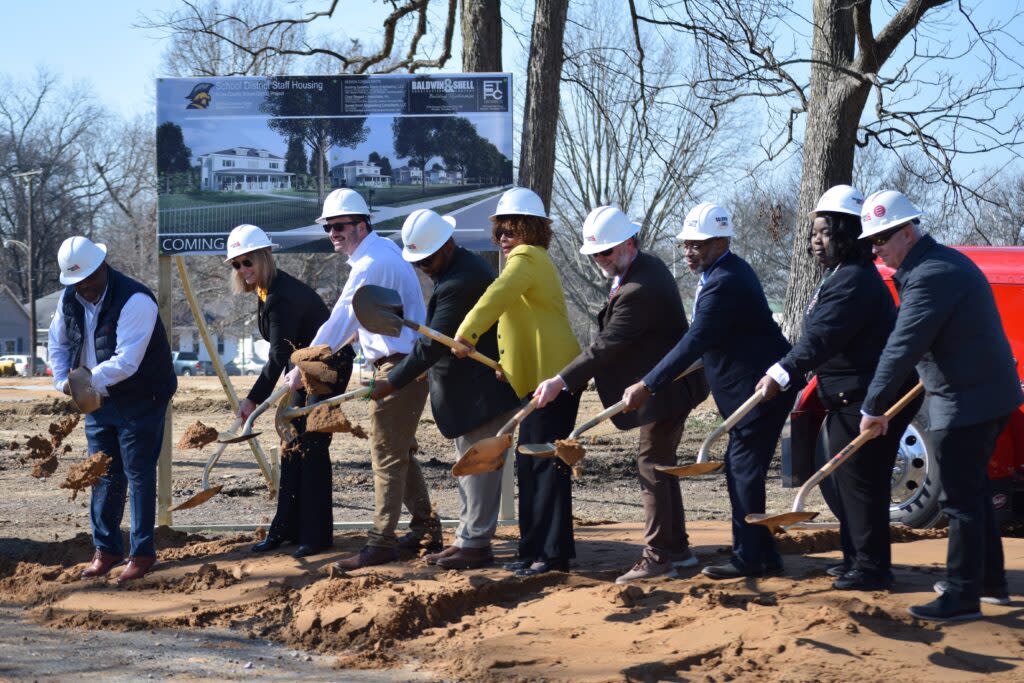 officials shoveling dirt at a groundbreaking