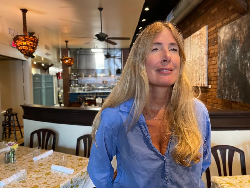 Last Resort Grill co-owner Melissa Clegg looks out the window of her restaurant on Sept. 2, 2022. The venerable downtown Athens eatery has been in business for 30 years.