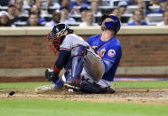 New York Mets' Pete Alonso scores against Atlanta Braves catcher Travis d'Arnaud during the sixth inning of the second game of a baseball doubleheader Saturday, Aug. 6, 2022, in New York. (AP Photo/Jessie Alcheh)