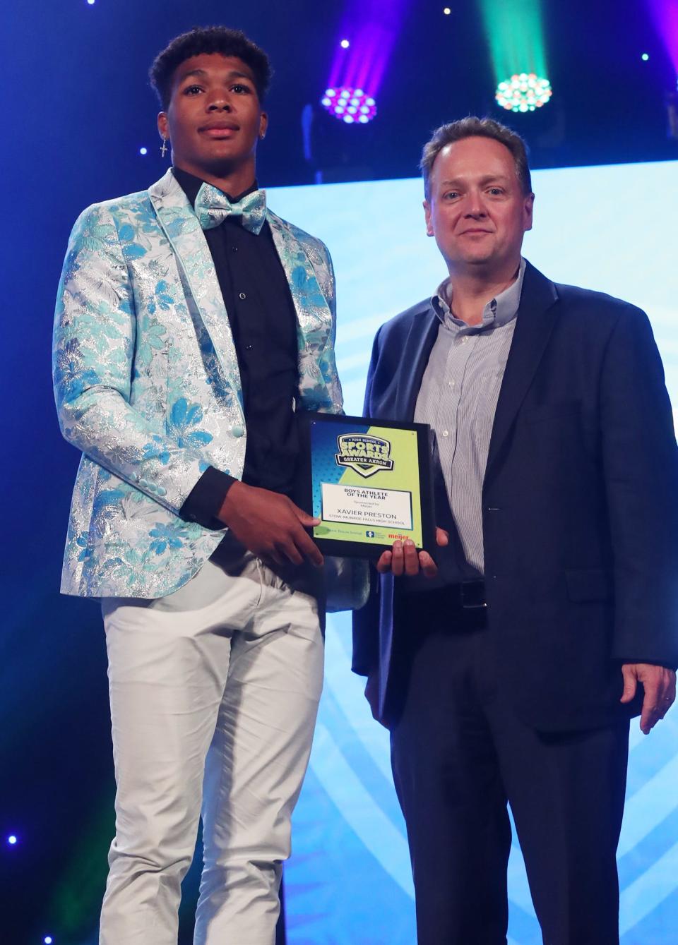 Stow-Munroe Falls' Xavier Preston Greater Akron Male Athlete of the Year poses with Beacon Journal editor Michael Shearer at the High School Sports All-Star Awards at the Civic Theatre in Akron on Friday.