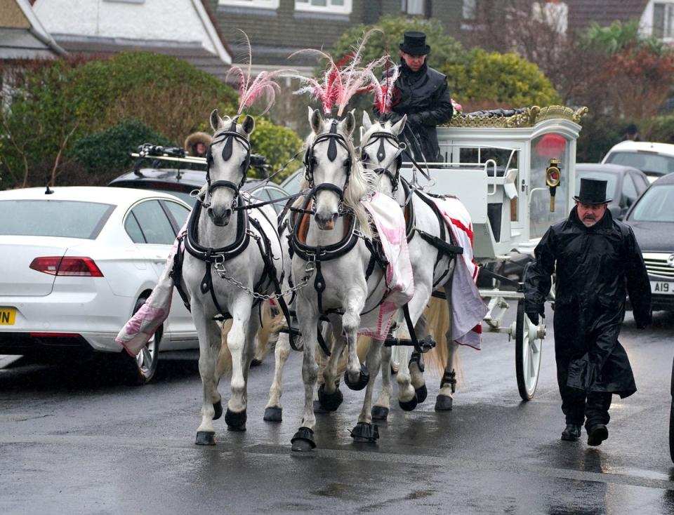 The coffin was transported on a horse drawn carriage (PA)