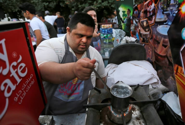 Hazem, a Syrian with Down's Syndrome, works at the Succet cafe in Damascus on July 11, 2018