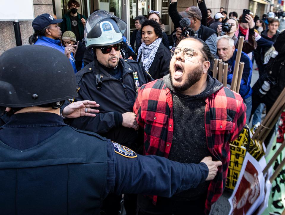 A pro-Palestinian protestor is arrested outside Columbia University in Manhattan April 22, 2024. Protestors gathered on the streets near the campus after school officials closed the campus and made all classes remote. This came after hundreds of pro-Palestinian protestors took over large parts of the campus last week.