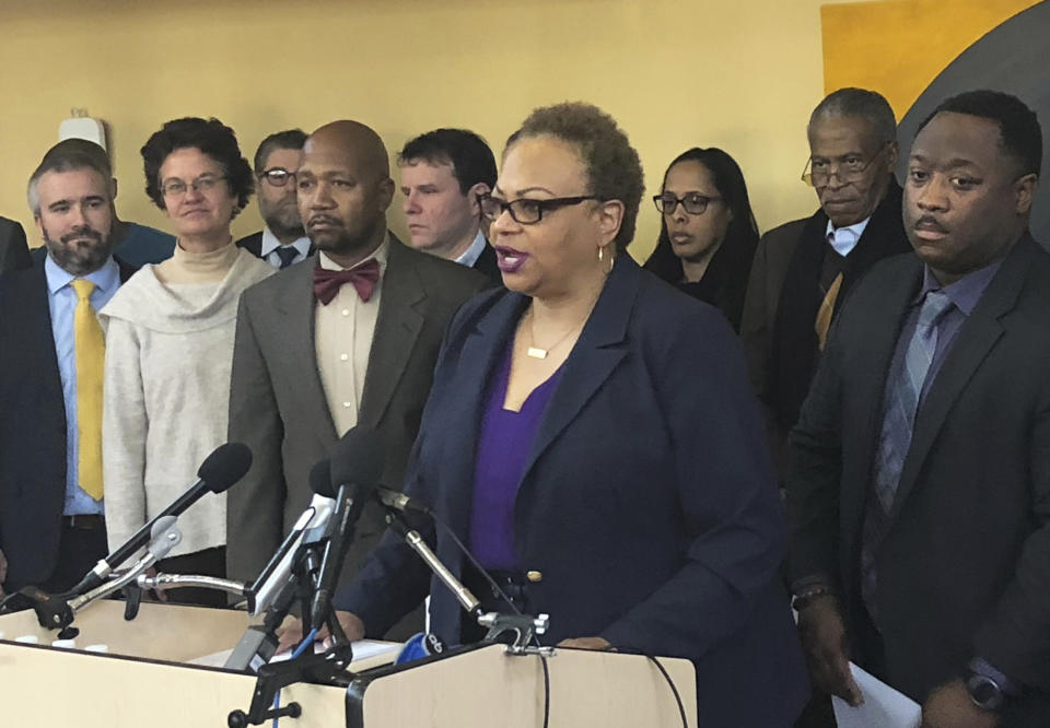 Dana Vickers Shelley, executive director of the American Civil Liberties Union of Maryland, speaks during a news briefing in unincorporated Prince George County, near College Park, Md. Wednesday, Dec. 12, 2018. White police officers in a Washington, D.C., suburb have used racist slurs, circulated text messages expressing a desire to “reinstitute lynching” and put a black face and Afro wig on a training dummy, according to a federal lawsuit filed Wednesday. (AP Photo/Michael Kunzelman)