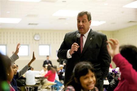 New Jersey Governor Chris Christie meets students before making an education announcement involving a new after-school dinner program for students in need at Dudley Family School in Camden, New Jersey January 23, 2014. REUTERS/Mark Makela