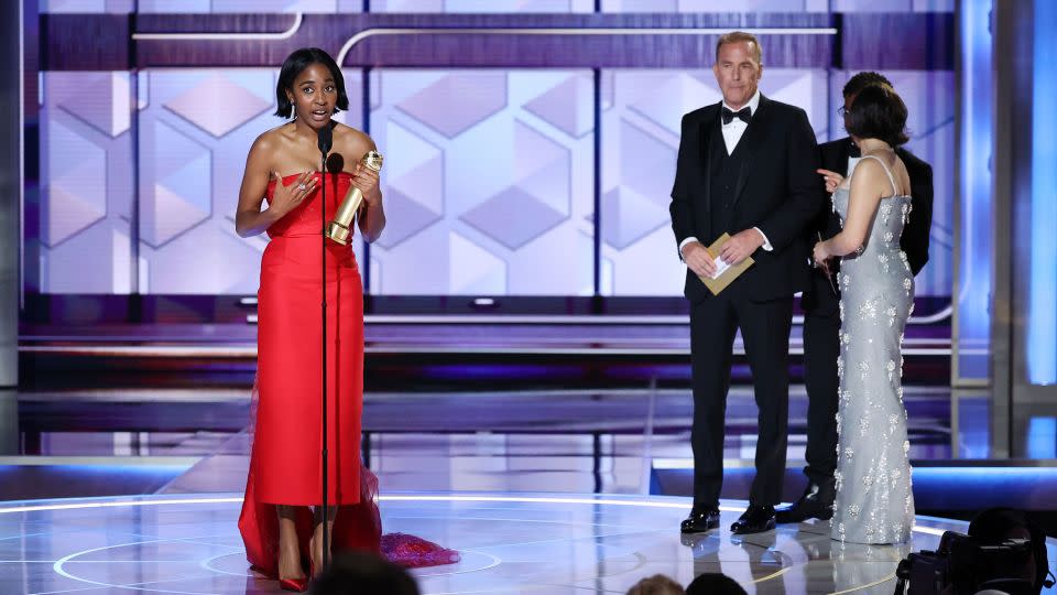 (From left) Ayo Edebiri and Kevin Costner on the 2024 Golden Globes stage in Beverly Hills. - Rich Polk/Golden Globes/Getty Images