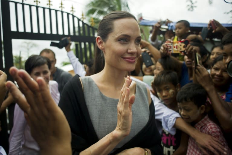 UN High Commissioner for Refugees (UNHCR) Goodwill Ambassador Angelina Jolie (C) pictured after meeting with women factory workers at a hostel in Hlaing Thar Yar Township in Yangon on August 1, 2015