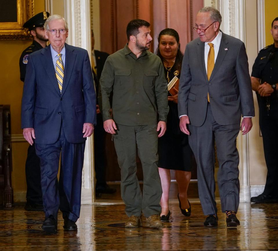 Ukrainian President Volodymyr Zelenskyy with Senate Majority Leader Chuck Schumer (D-NY), right, and Senate Minority Leader Mitch McConnell (R-KY), left, walking to a meeting with Senators at the United States Capitol on September 21, 2023.