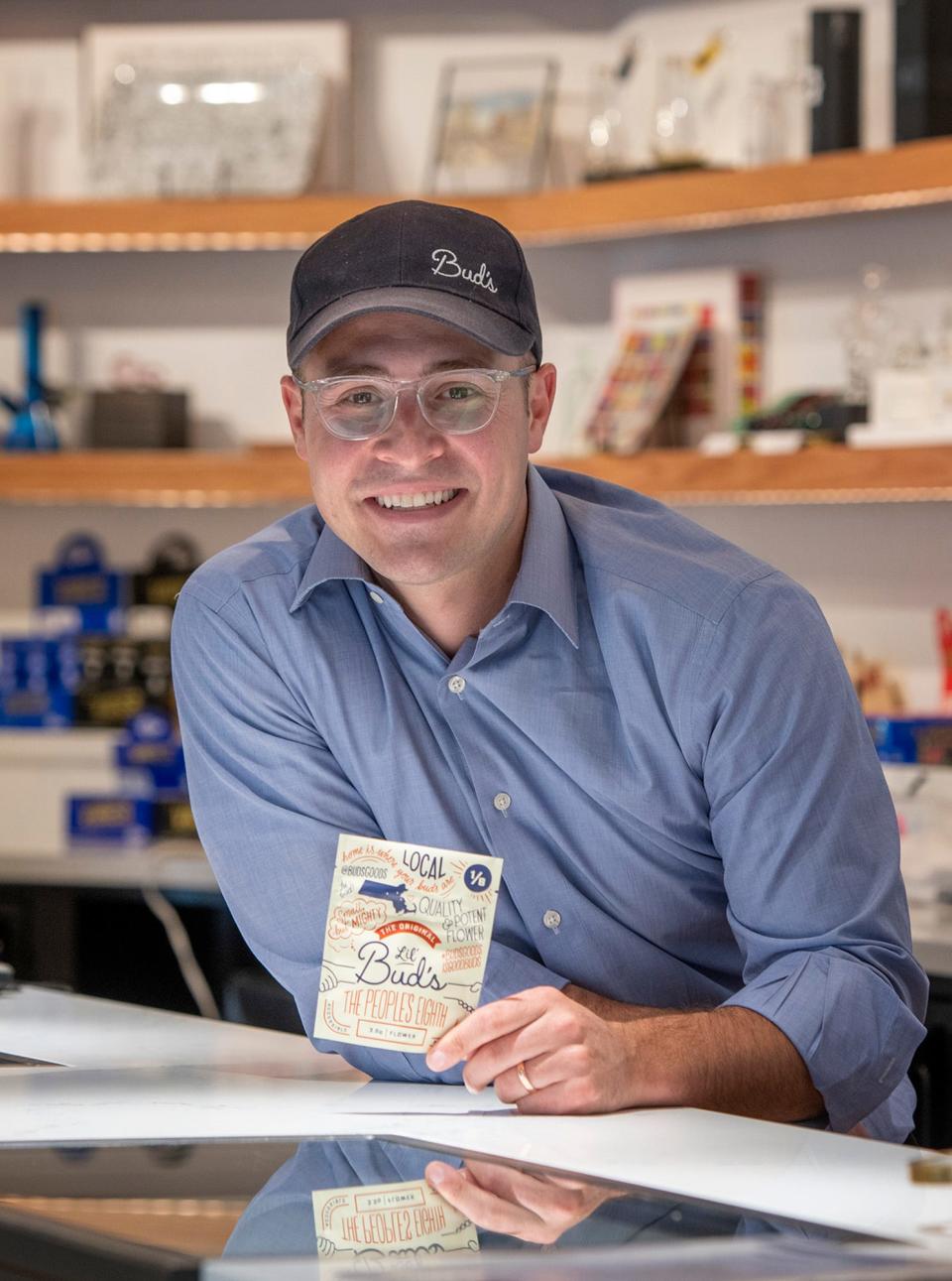 Alex Mazin, owner of Bud's Goods, holds a package of Lil' Bud's cannabis flower in his West Boylston Street shop.