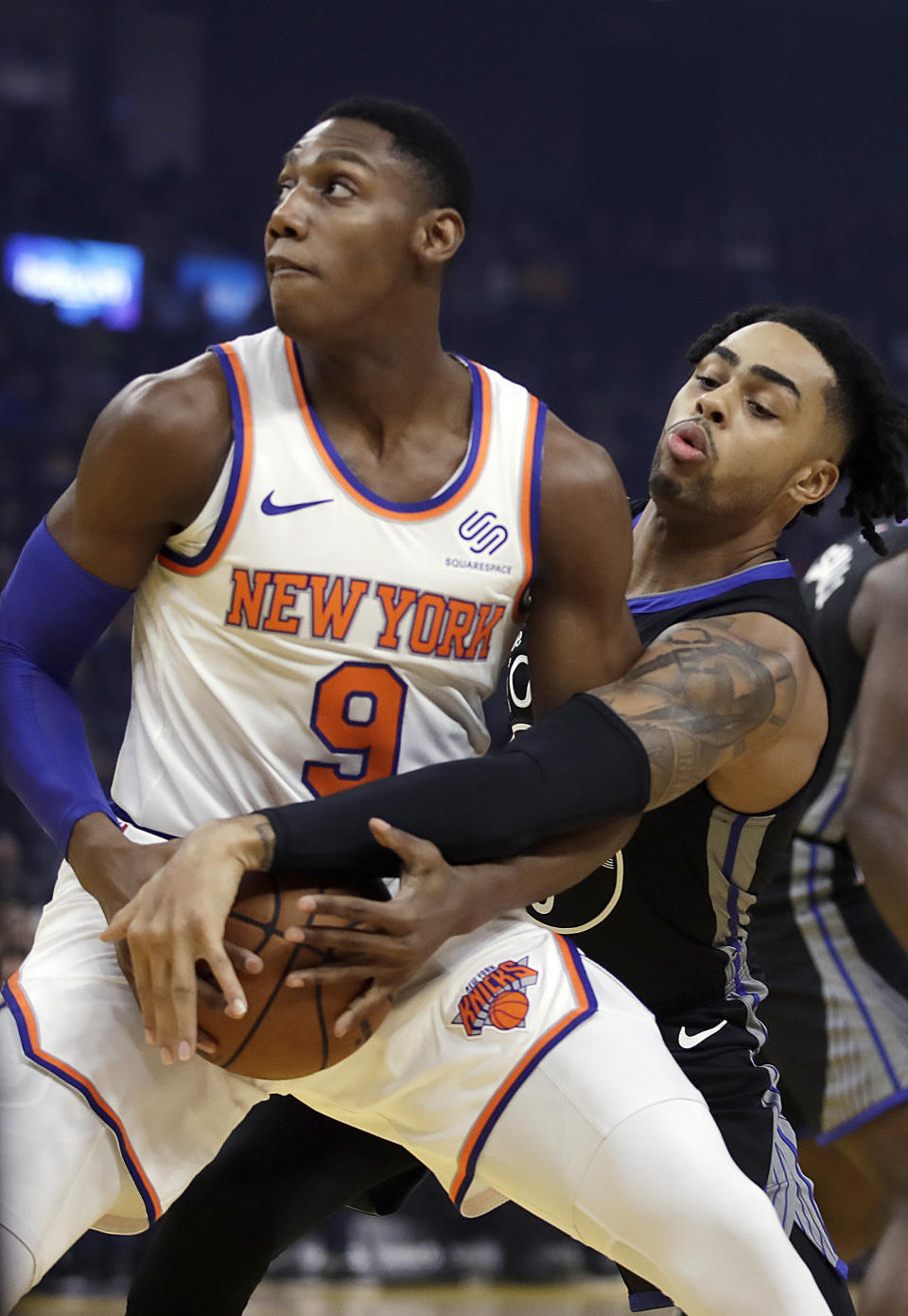 New York Knicks' RJ Barrett (9) keeps the ball from Golden State Warriors' D'Angelo Russell in the first half of an NBA basketball game, Wednesday, Dec. 11, 2019, in San Francisco. (AP Photo/Ben Margot)