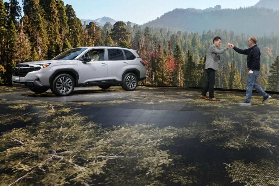 Atsushi Osaki, left, President and CEO of Subaru Corp., introduces Jeff Walters, President and COO of Subaru of America, as they introduce the 2025 Subaru Forester at the AutoMobility LA Auto Show, Thursday, Thursday, Nov. 16, 2023, in Los Angeles. (AP Photo/Damian Dovarganes)