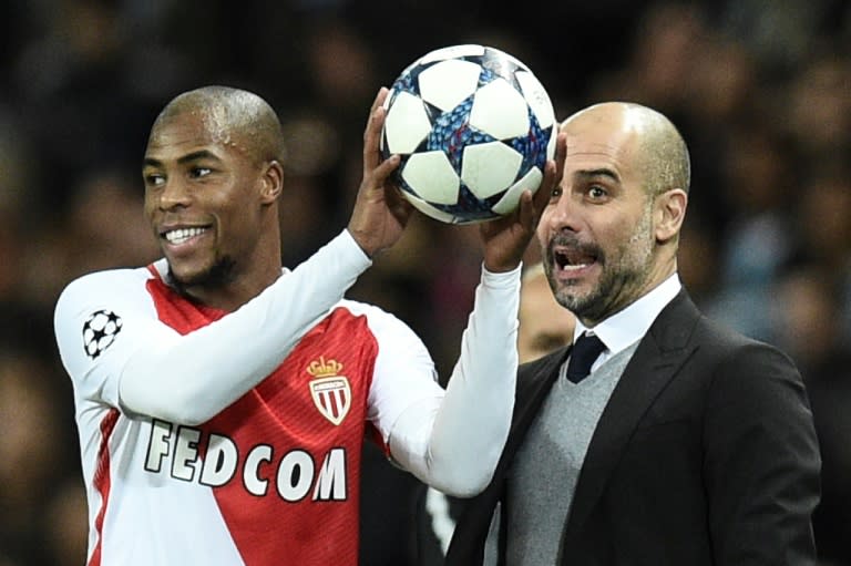 Manchester City manager Pep Guardiola (R) pictured with Monaco's French defender Djibril Sidibe during the Champions League Round of 16 first-leg at the Etihad Stadium in Manchester, north west England on February 21, 2017