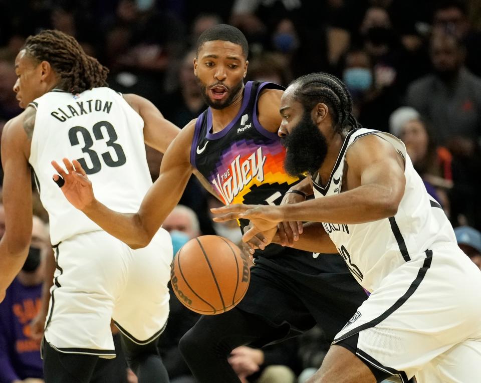 Feb 1, 2022; Phoenix, Arizona, United States;  Phoenix Suns forward Mikal Bridges (25) defends Brooklyn Nets guard James Harden (13) during the first quarter at Footprint Center. Mandatory Credit: Michael Chow-Arizona Republic