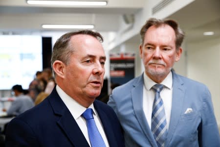 Britain's Secretary of State for International Trade Liam Fox speaks next to Britain's Chief Trade Negotiation Adviser Crawford Falconer at Harris Westminster Sixth Form college in central London