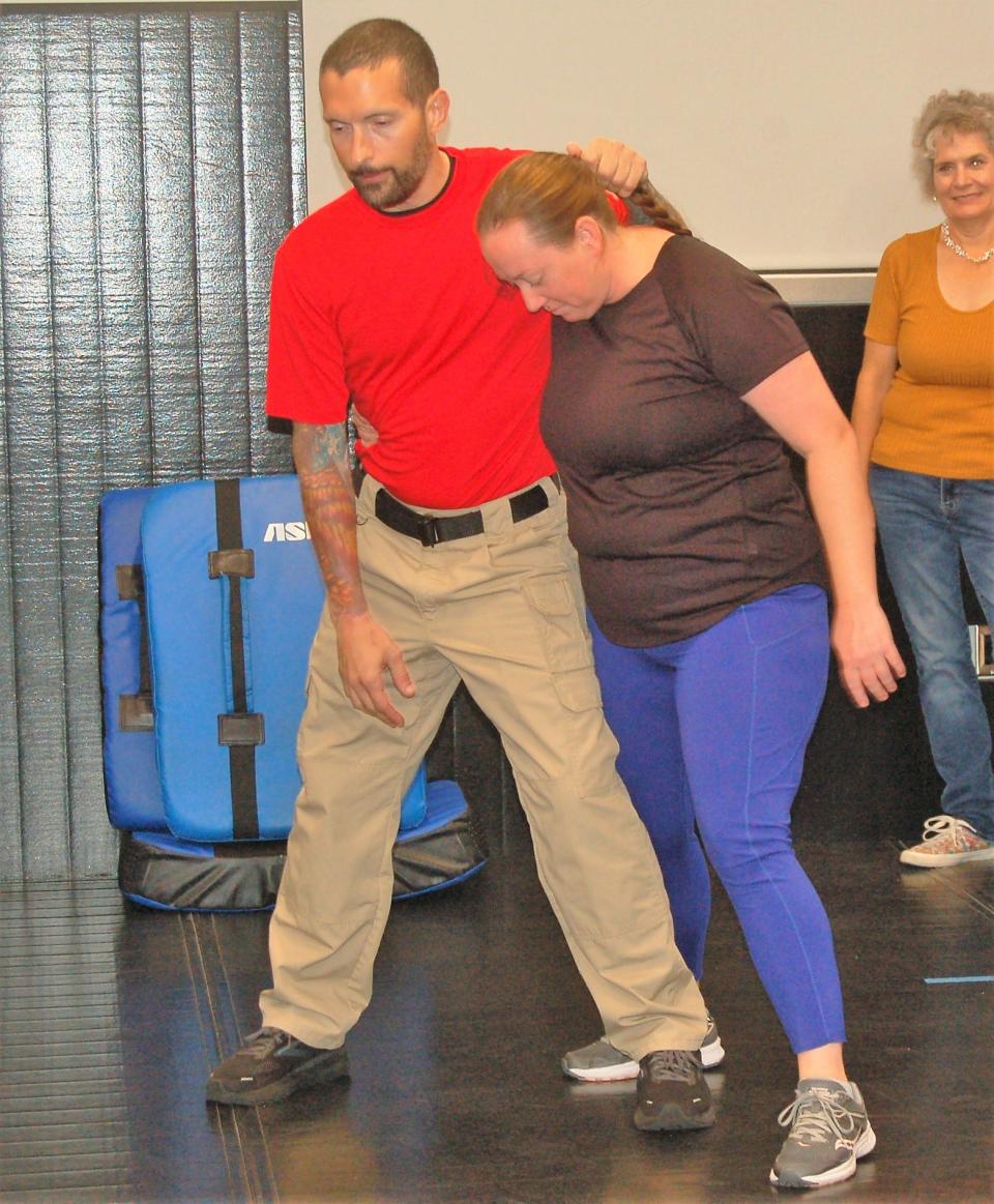 North Port police Sgt. Shannon Fortuno demonstrates how to escape a hair hold with assistance from her husband, Officer James Fortuno.