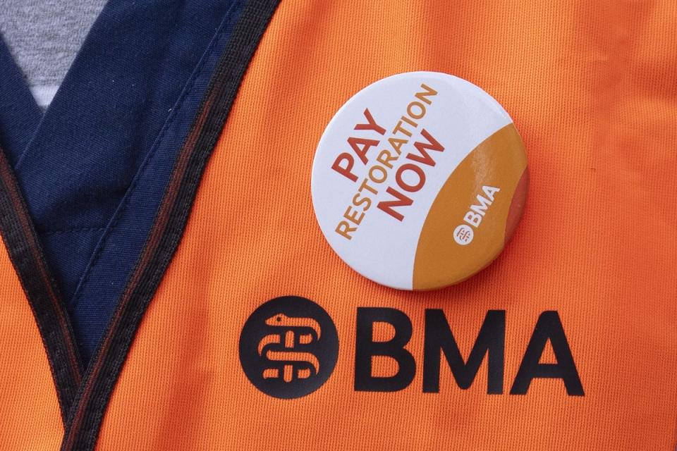 A junior doctor sporting a BMA badge backing the pay rise initiative (PA)