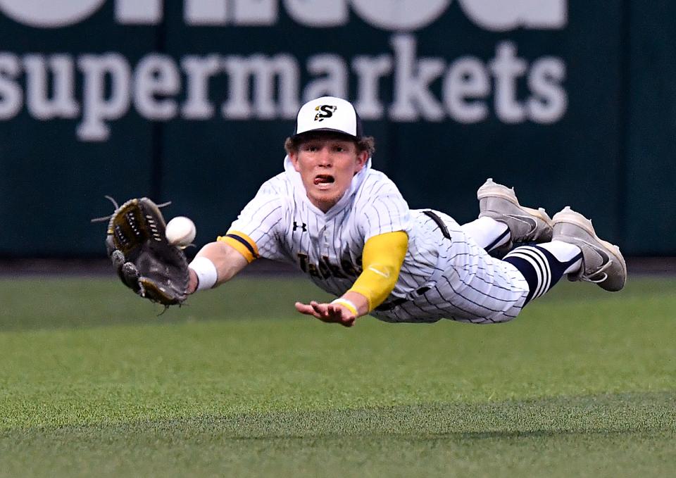 Stephenville outfielder Eli Hiitola makes a successful diving catch for a low ball hit deep by a Graham batter during Friday’s baseball playoff at Abilene Christian University May 19.
