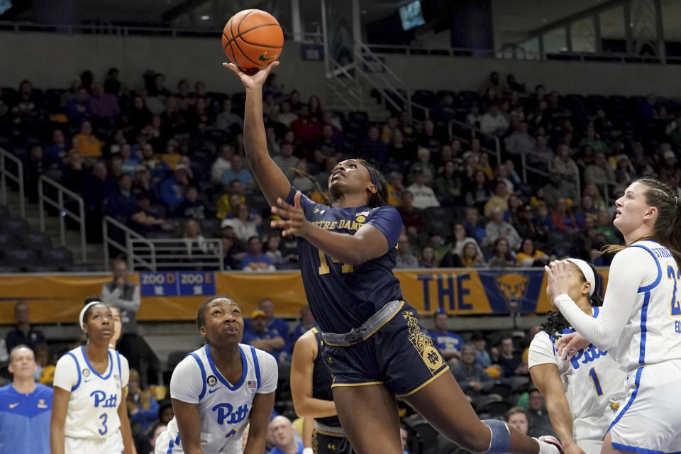 Notre Dame guard KK Bransford, center, lays up the ball against Pittsburgh during the first half of an NCCA college basketball game in Pittsburgh, Sunday, Feb. 19, 2023. (AP Photo/Matt Freed)