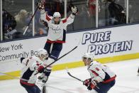 Washington Capitals' Alex Ovechkin (8) and Dmitry Orlov (9) celebrate a goal by Tom Wilson (43) during the third period of an NHL hockey game against the New York Islanders Saturday, Jan. 18, 2020, in Uniondale, N.Y. The Capitals won 6-4. (AP Photo/Frank Franklin II)