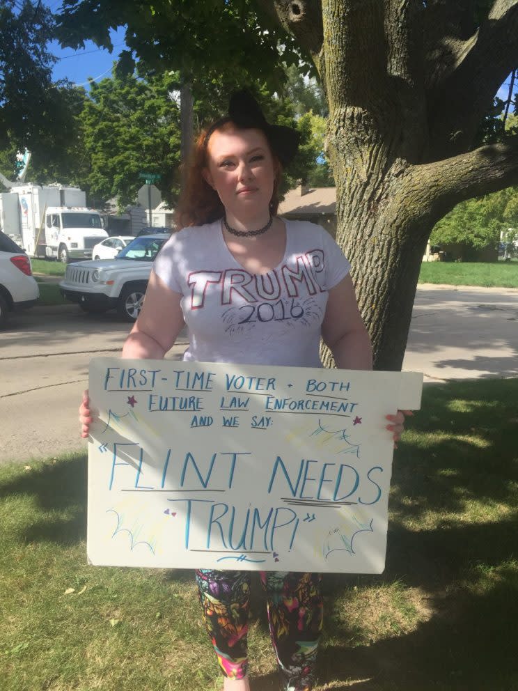 Brittany Ross, of Mount Morris, Mi., shows her support for Donald Trump outside Flint's Bethel United Methodist Church. The 21-year-old is a first-time voter and said she is backing the Republican nominee for president because he’s not an establishment politician. (Photo: Jeremy Drummond/Yahoo News) 