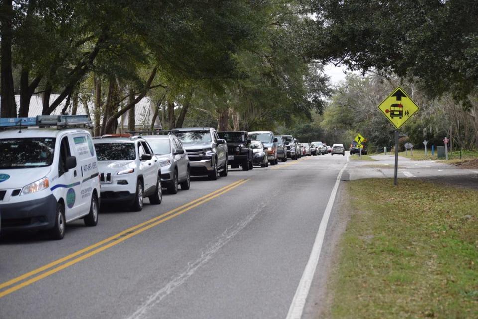 Drivers wait on Squire Pope Road outside a state-run COVID-19 testing site on Hilton Head Island on Monday, Jan. 10, 2022.