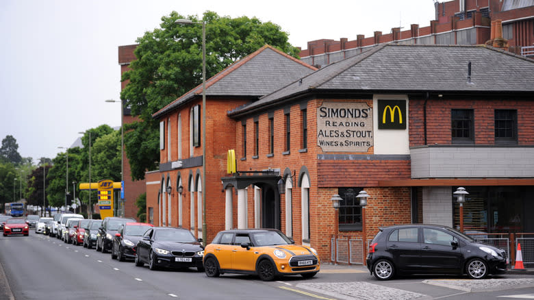 Cars queue around a McDonnald's