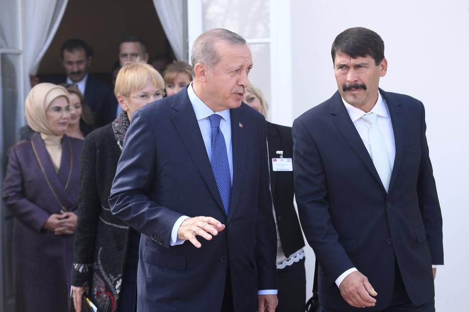 Turkish President Recep Tayyip Erdogan, left, chats with Hungarian President Janos Ader as he steps out on the terrace of the presidential Alexander Palace in Budapest, Hungary, Monday, Oct. 8, 2018. Erdogan is paying a two-day official visit to Hungary. (Tamas Kovacs/MTI via AP)