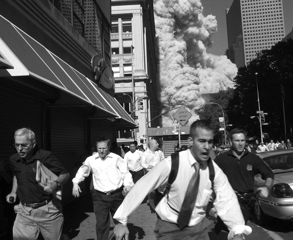 Before: People on Fulton Street run from the collapse of one of the World Trade Center towers, Sept. 11, 2001. After: Fulton Street sixteen years after the collapse of the towers, Aug. 23, 2017. (Photos: Suzanne Plunkett/AP, Gordon Donovan/Yahoo News)