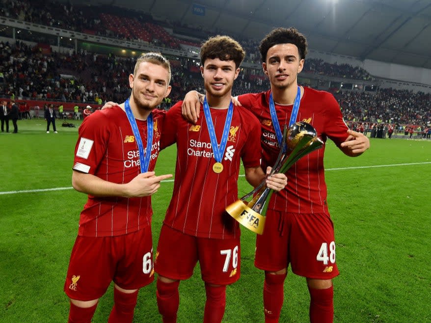 Neco Williams (centre) poses with Club World Cup trophyLiverpool FC via Getty Images